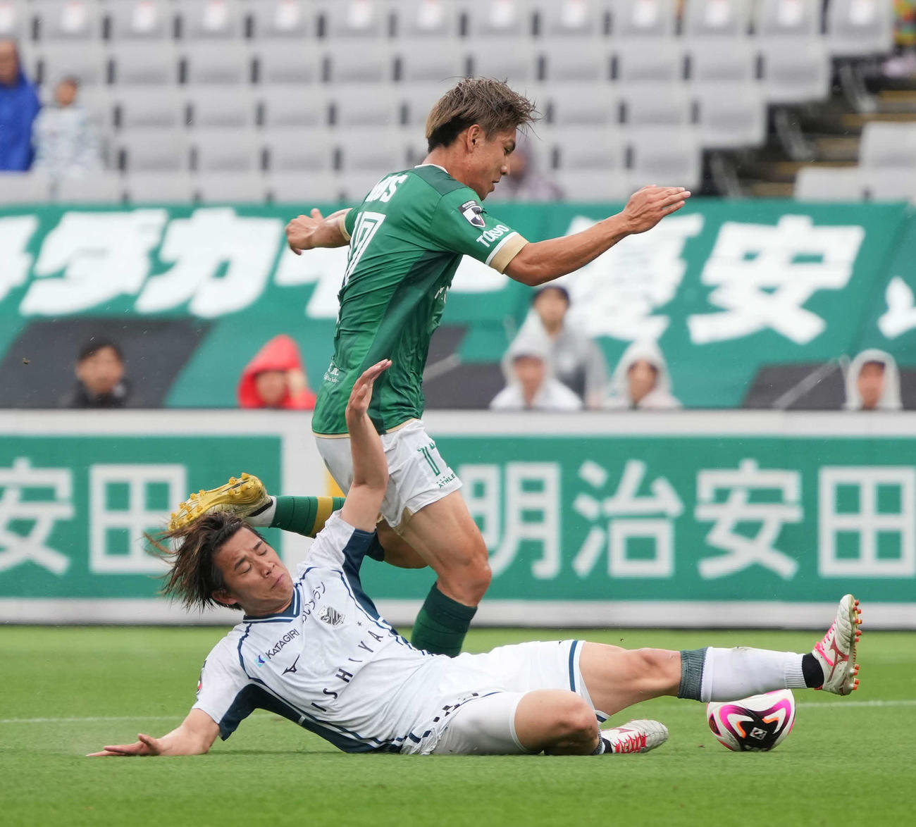 東京V対札幌、前半、札幌近藤（手前下）は東京V稲見と競り合う（撮影・小沢裕）