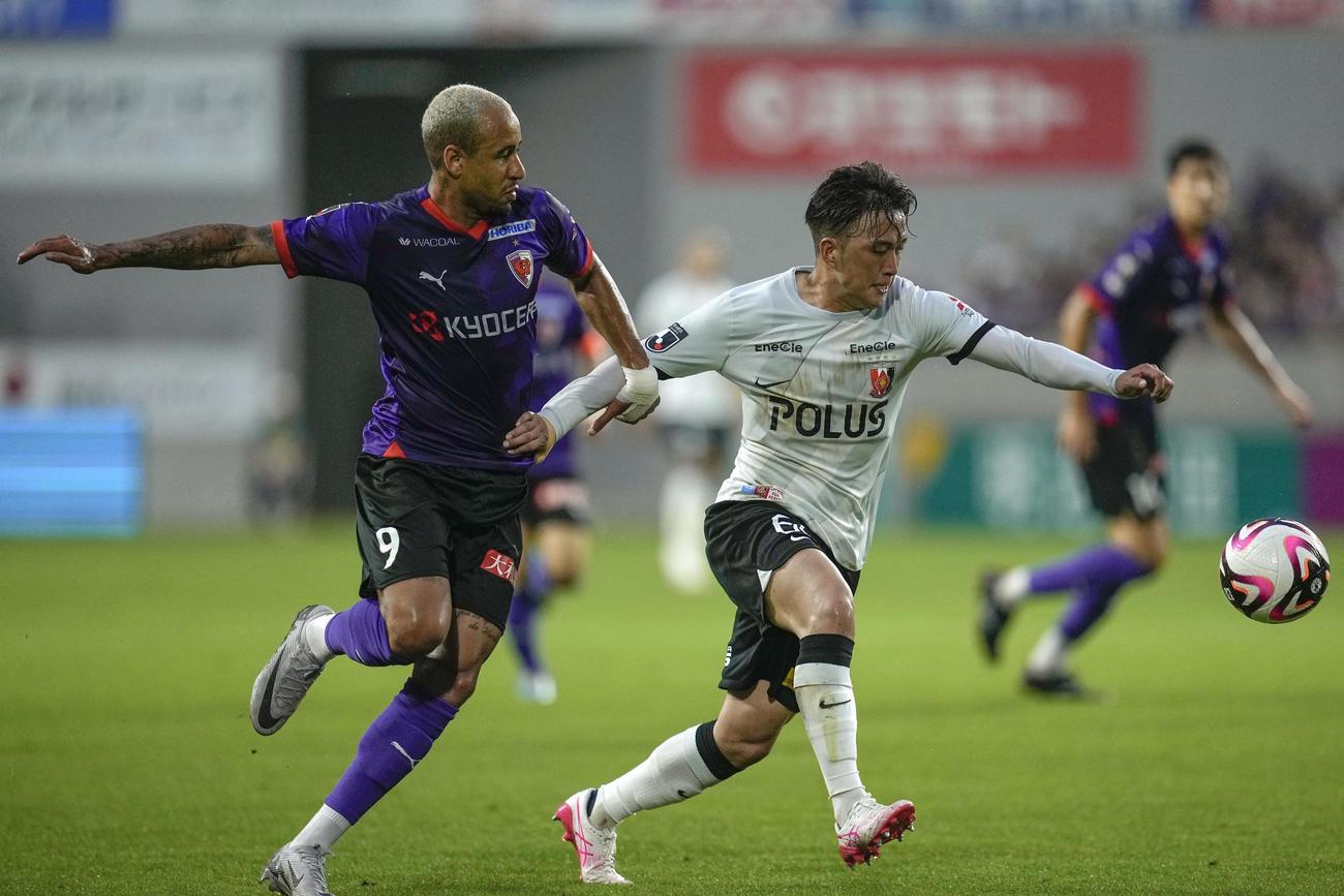 前半、競り合う京都・マルコトゥーリオ（左）と浦和・大畑（共同）