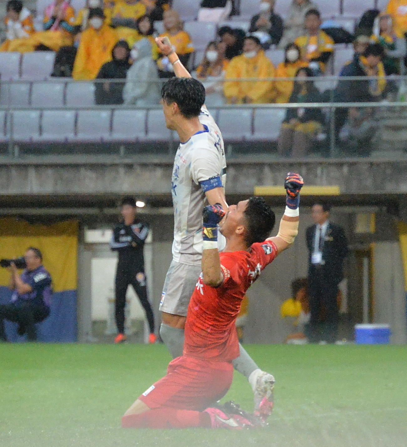 仙台対秋田　試合終了のホイッスルで両手を突き上げるJ2秋田のGK山田（手前）（撮影・浜本神威）