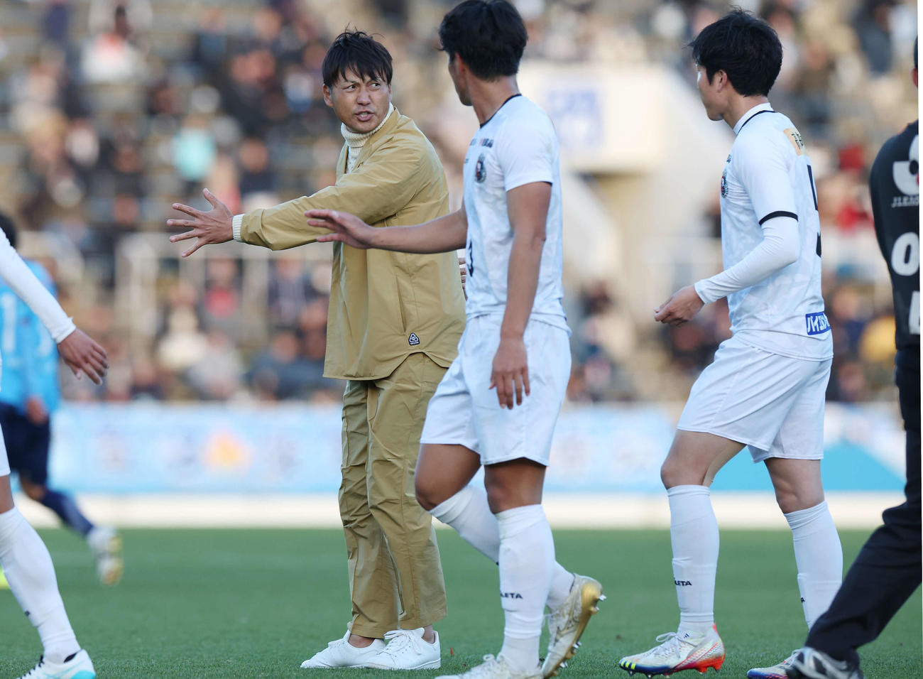 YS横浜対高知ユナイテッド　前半を終え、高知ユナイテッド田辺（右）に身ぶり手ぶり指示する吉本監督（左）（撮影・宮地輝）