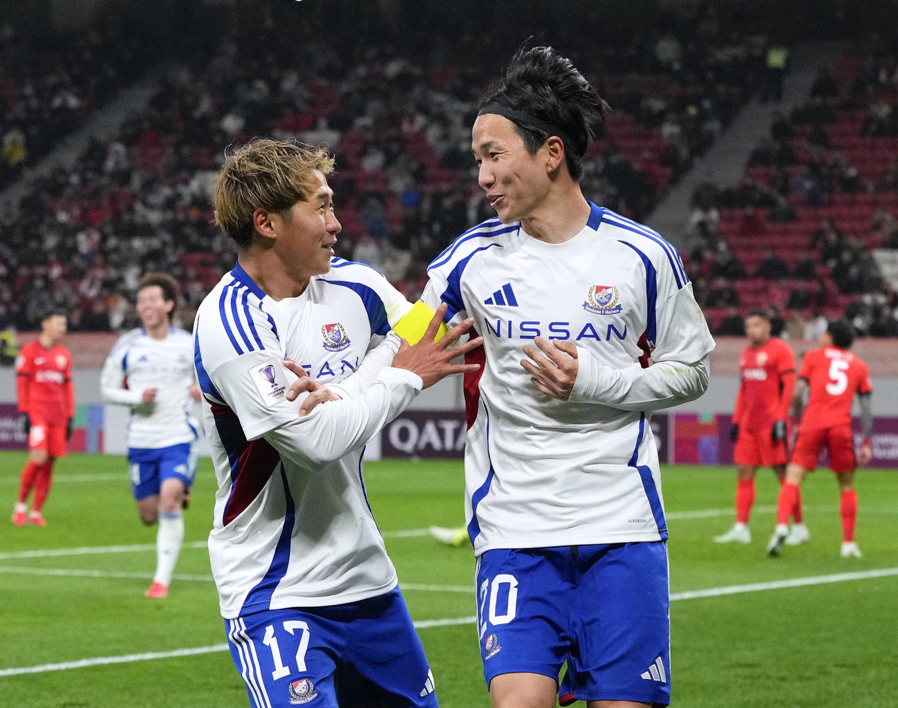 横浜M―上海海港　後半、チーム2点目のゴールを決め、祝福される横浜M・天野（右）＝上海（共同）