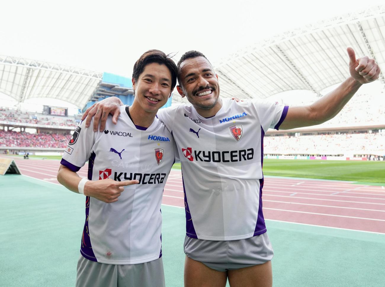 新潟に勝利し、笑顔で写真に納まる京都・奥川（左）とラファエルエリアス（共同）