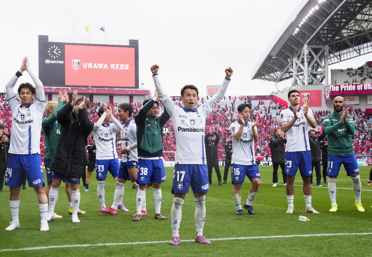 浦和に競り勝ち、サポーターの声援に応える山下（中央）らG大阪の選手たち（共同）