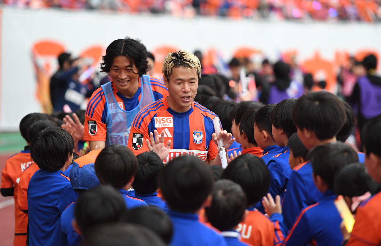 試合終了後、スクール生とタッチする新潟・堀米主将（中央）（撮影・小林忠）