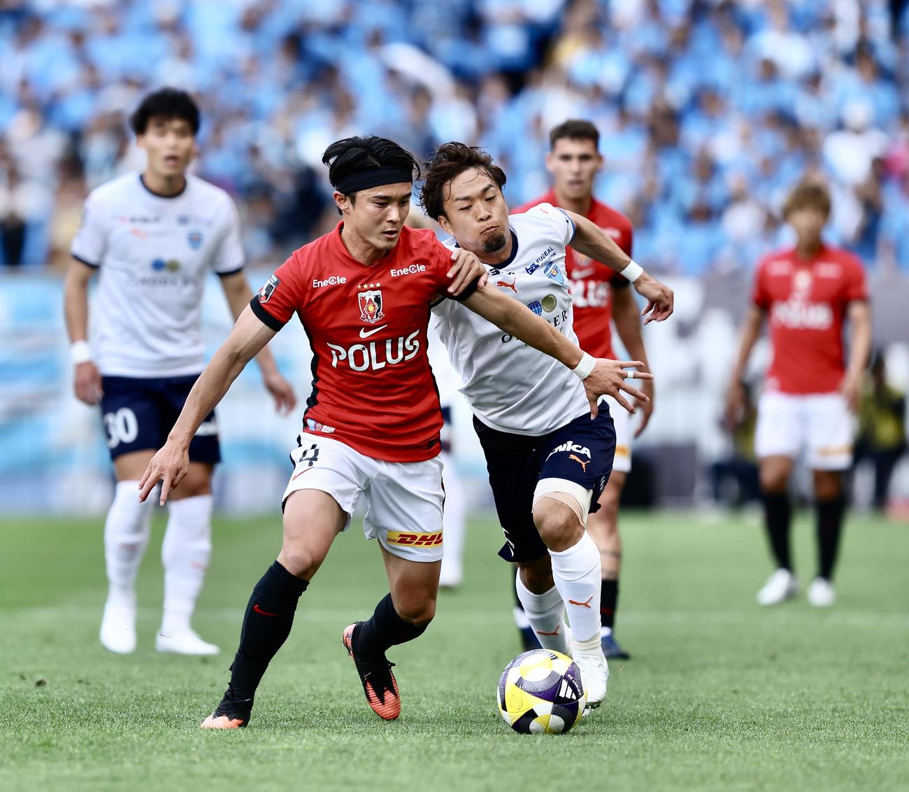浦和対横浜FC　前半、競り合う浦和石原（左）と横浜FC駒井（撮影・河田真司）
