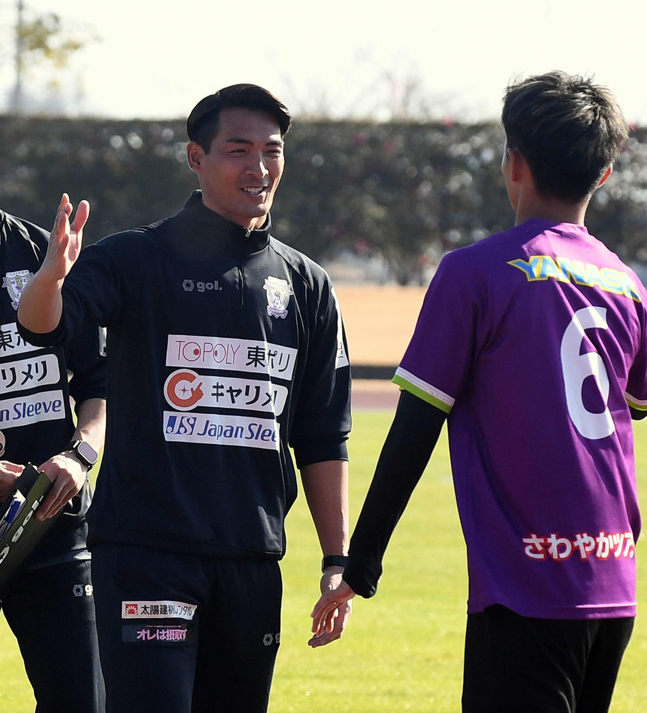 笑顔で選手をピッチへ送り出す藤枝槙野監督