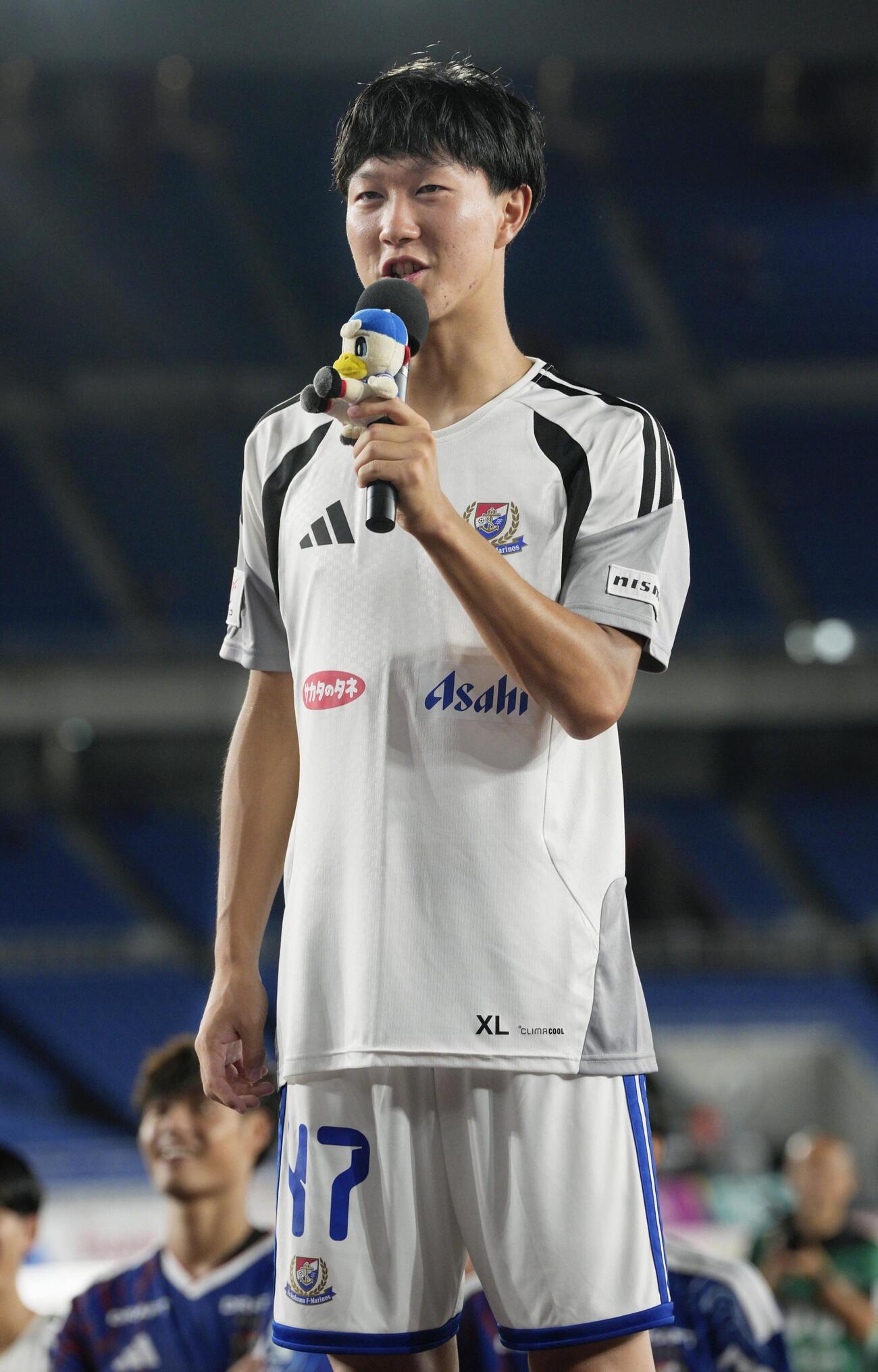 神戸に競り勝ち、お立ち台でサポーターにあいさつする横浜M三井寺（共同）