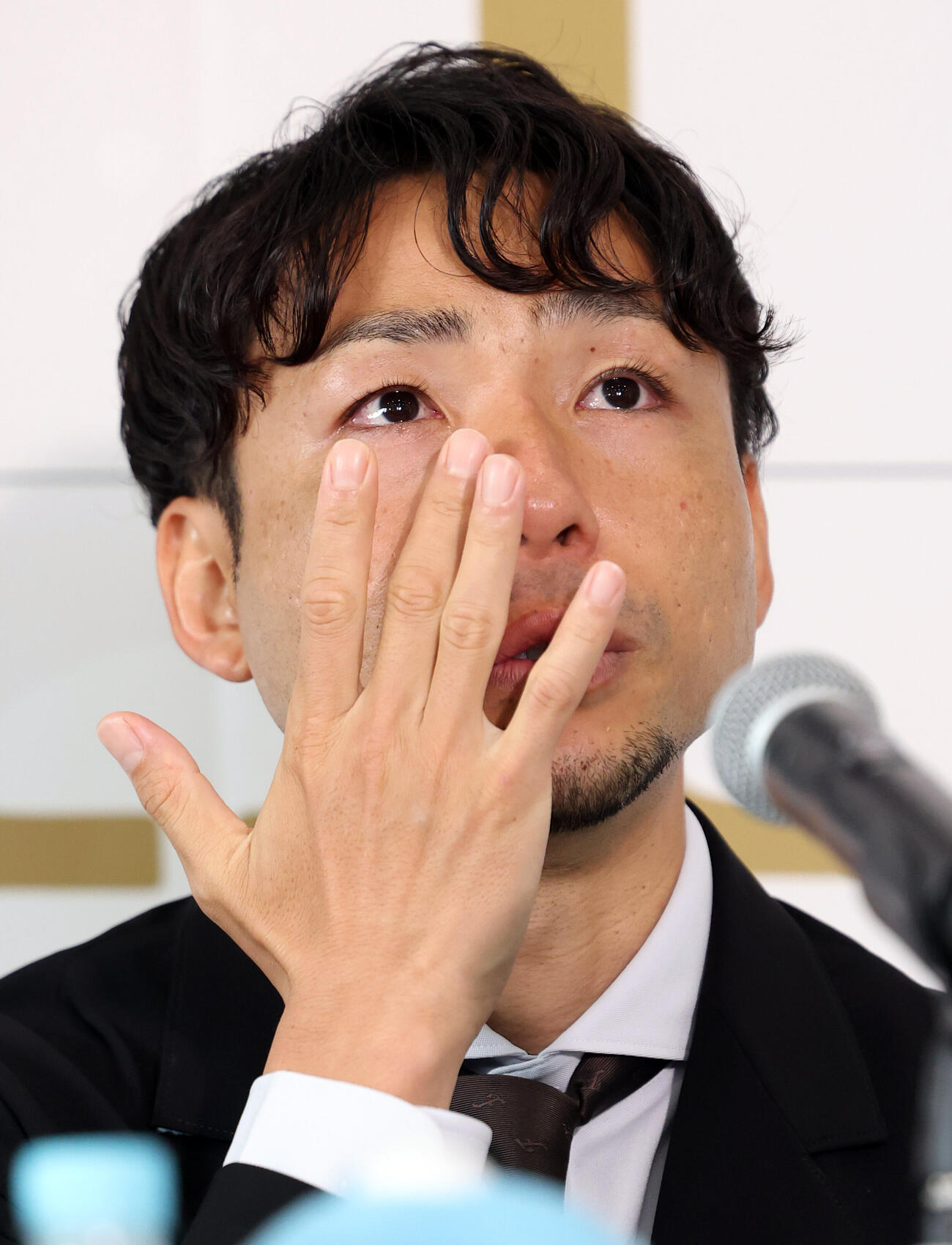 引退会見で涙をぬぐう川﨑F小林悠（撮影・浅見桂子）