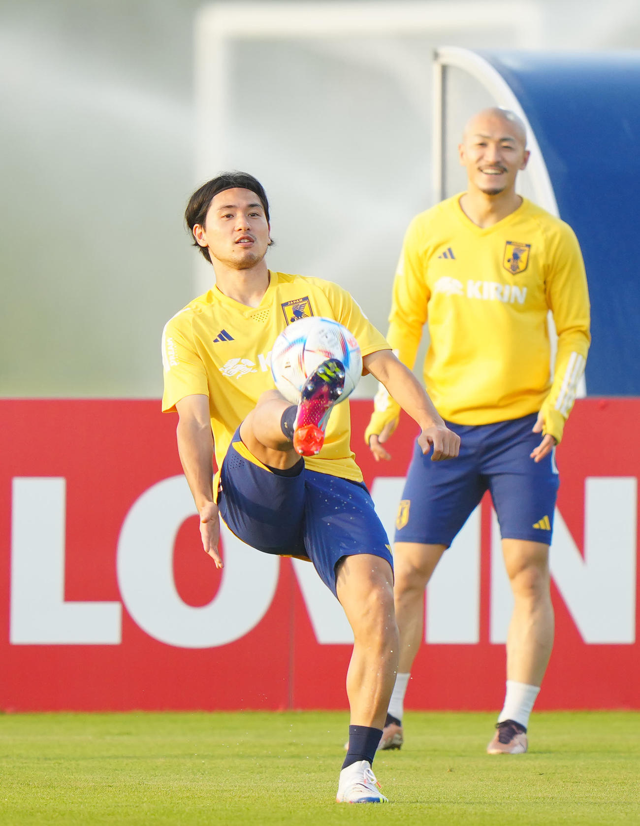 練習前、パス回しする南野拓実。後方は前田大然（2022年11月20日撮影）