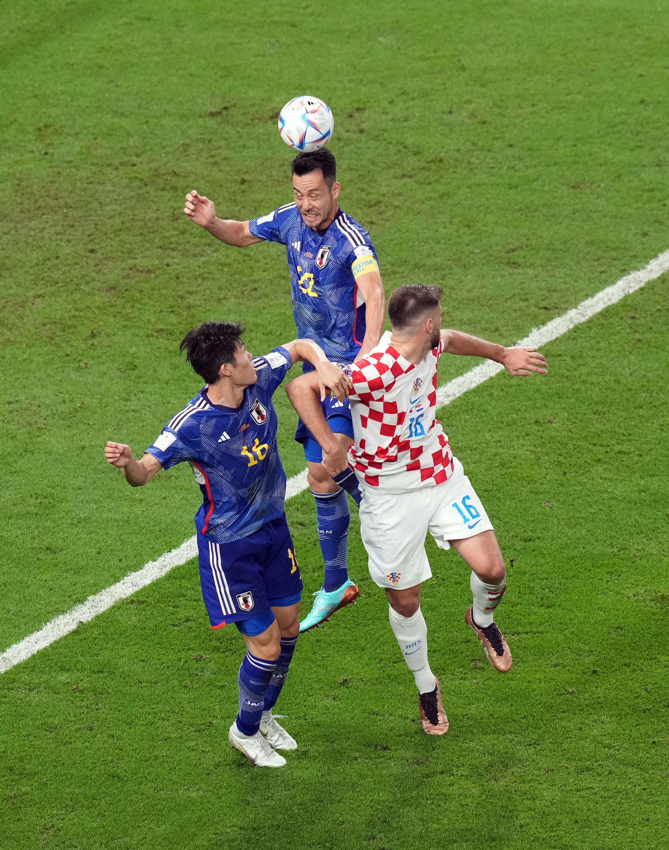 日本対クロアチア　前半、吉田（中央）はクロアチアのペトコビッチと競り合いハイボールをクリア。左は冨安（撮影・パオロ　ヌッチ）