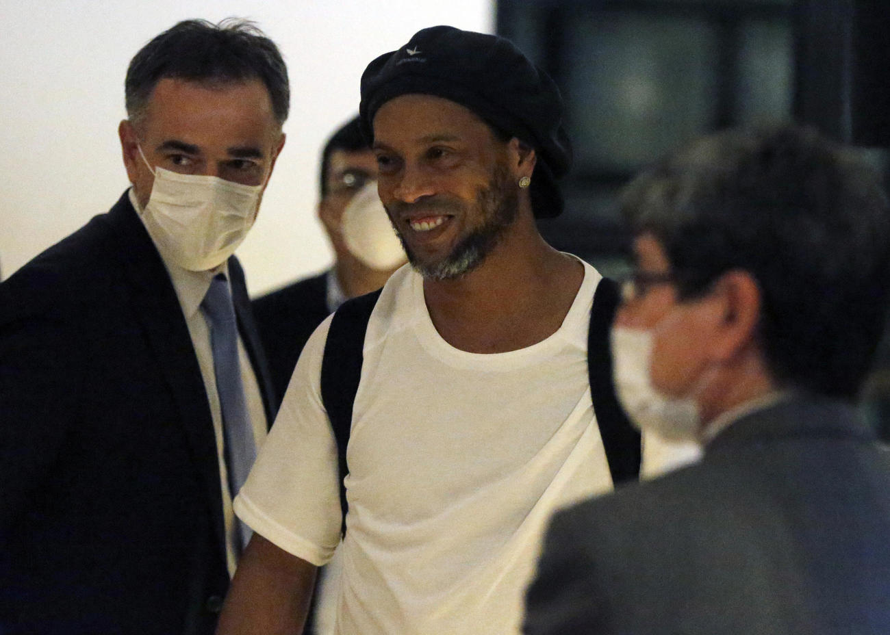 保釈され、軟禁されるホテルに到着したロナウジーニョ氏（中央）（AP）
