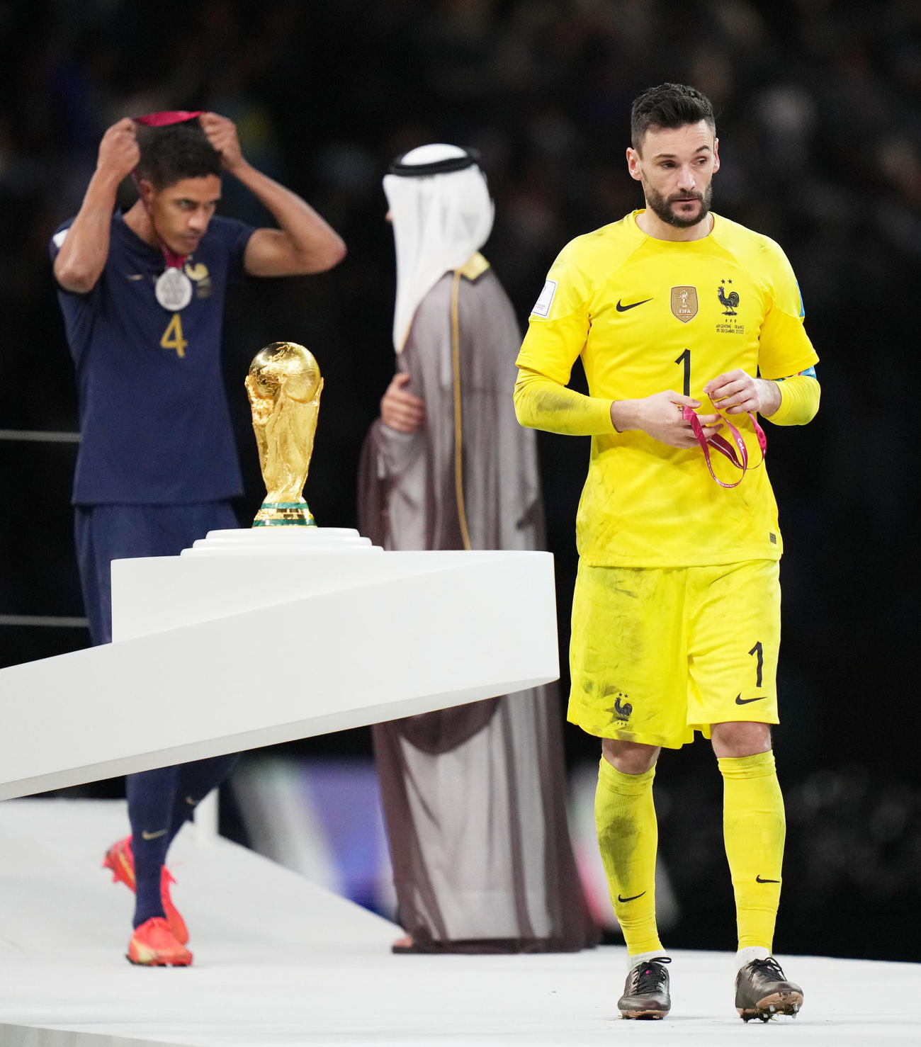 W杯カタール大会　表彰式で、もらったメダルをすぐに外すフランスGKロリス（右）とバラン（2022年12月18日撮影）