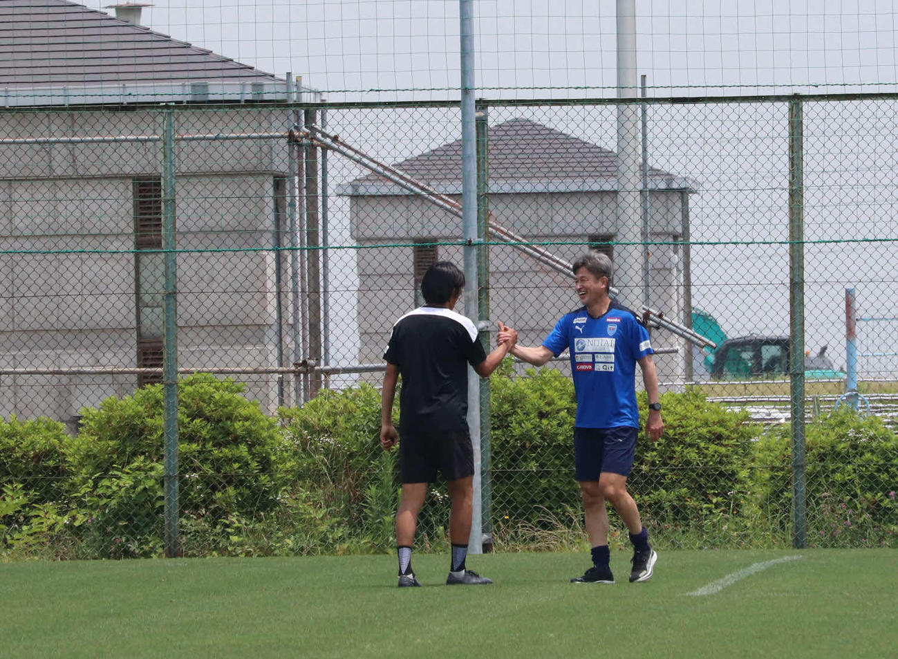 インターバル走を終え、中村俊輔コーチ（左）と握手するカズ