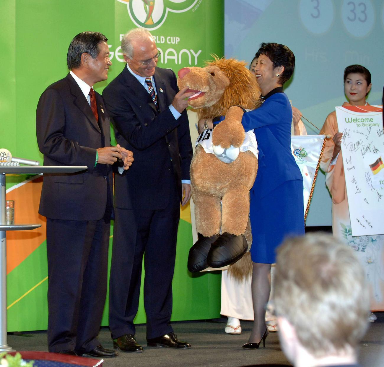 W杯ドイツ大会世界プロモーションイベント　フランツ・ベッケンバウアー大会組織委員会長（中央）から高円宮妃久子殿下へマスコットのぬいぐるみが贈られる。左は川淵三郎キャプテン（2005年10月06日）