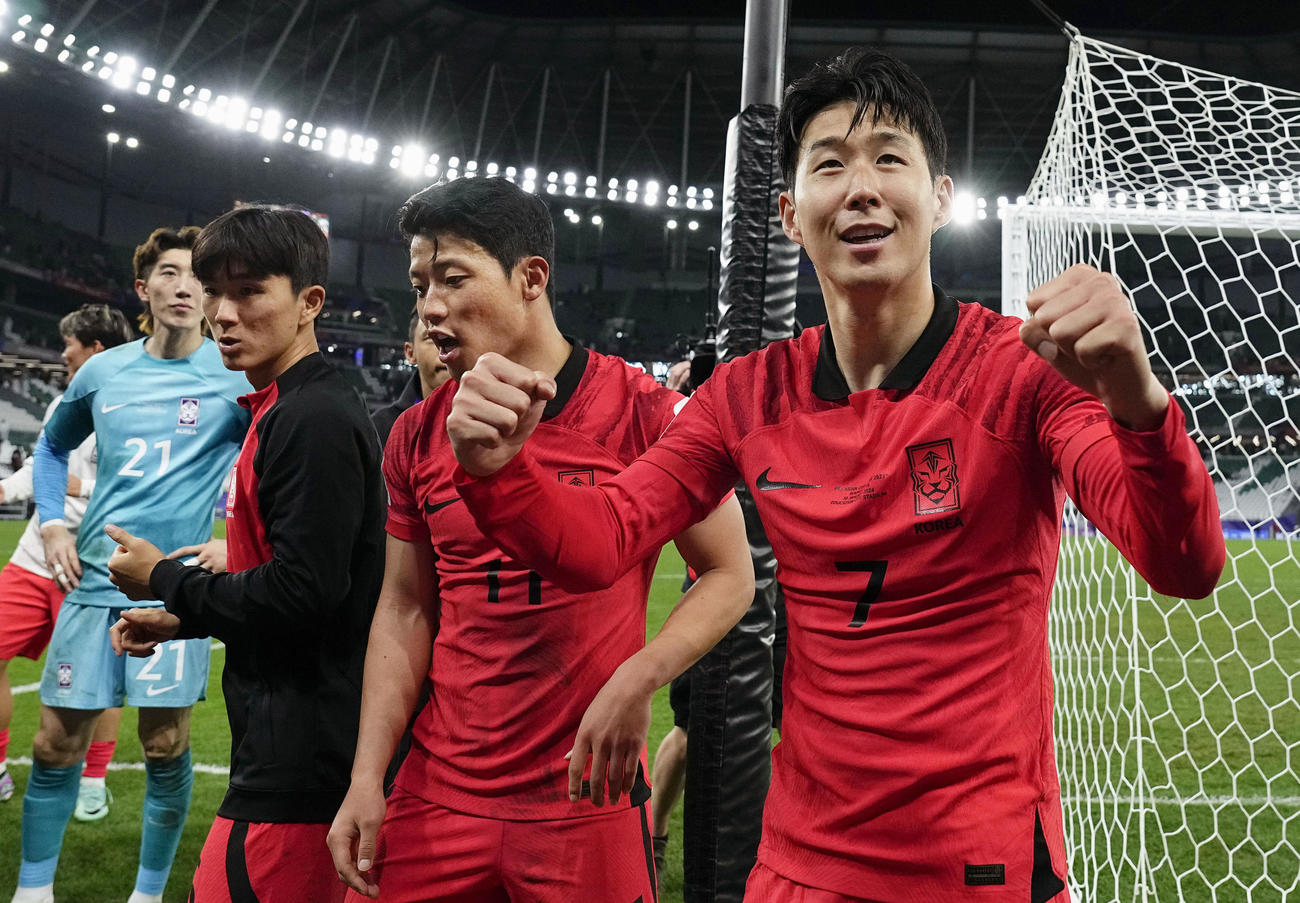 準々決勝進出を決め、観客の声援に応える韓国の孫興民（右端）＝アルラヤン（共同）