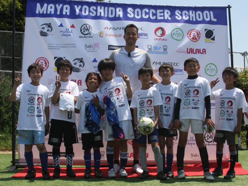 サッカー教室で参加者の子どもたちと記念撮影する吉田麻也