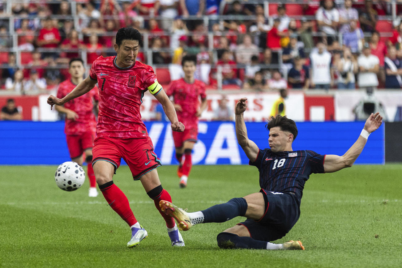 国際親善試合　米国代表にタックルされる韓国代表のソン・フンミン（AP）
