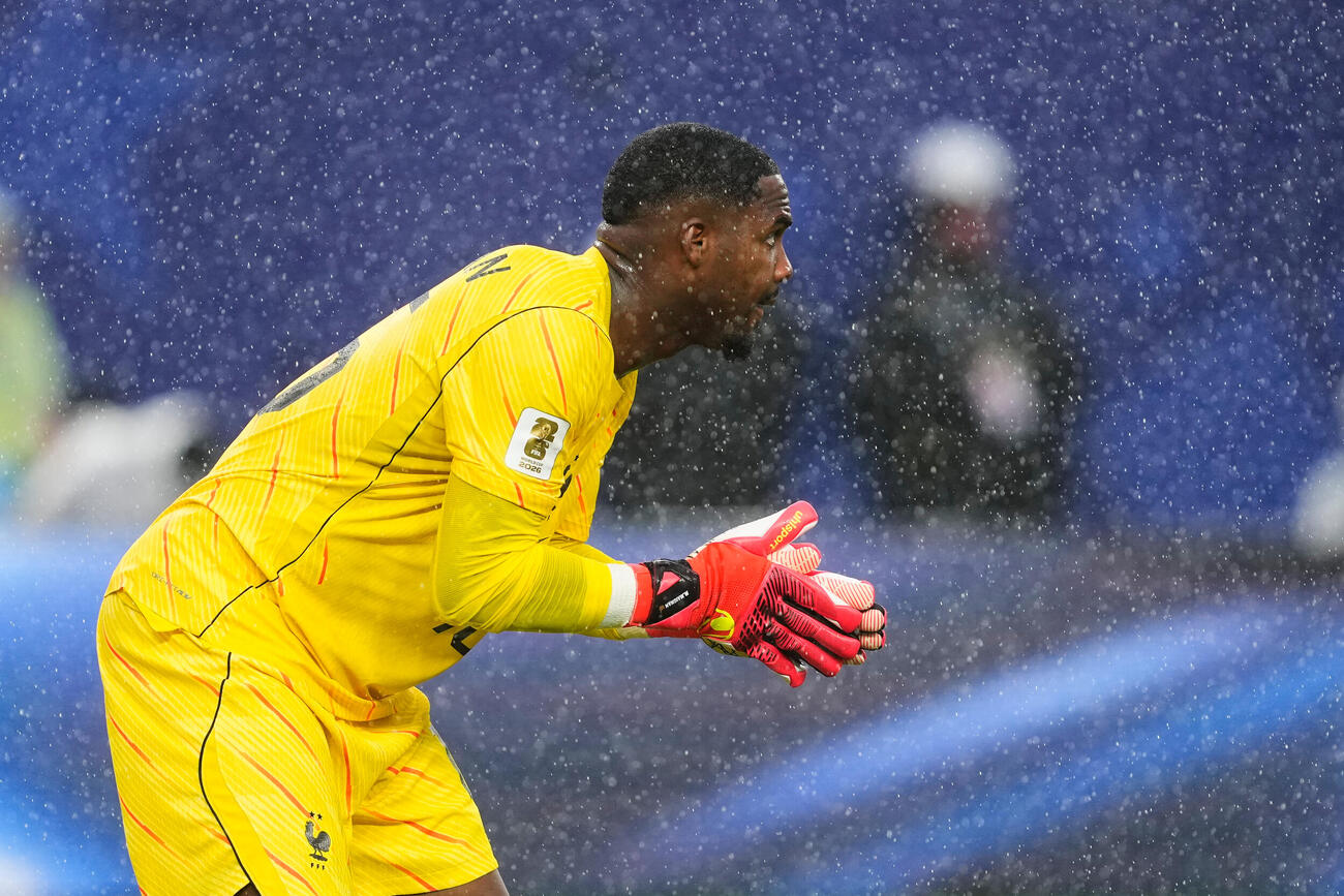 雨の中プレーするフランスGKメニャン（AP）