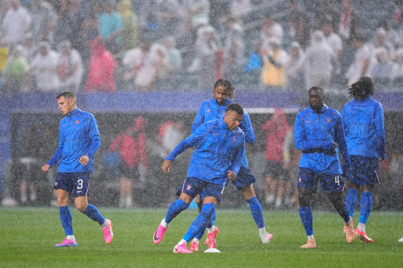 試合再開を前にウォーミングアップを行うフランス代表（AP）