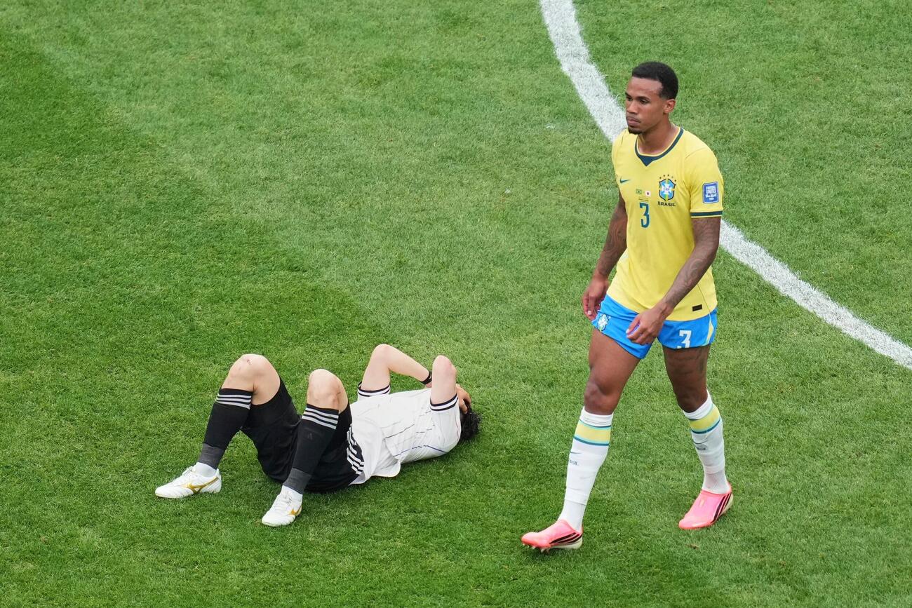 敗戦直後、ピッチに倒れ込みユニホームで顔を覆う田中碧。右はブラジルDFガブリエル（AP）