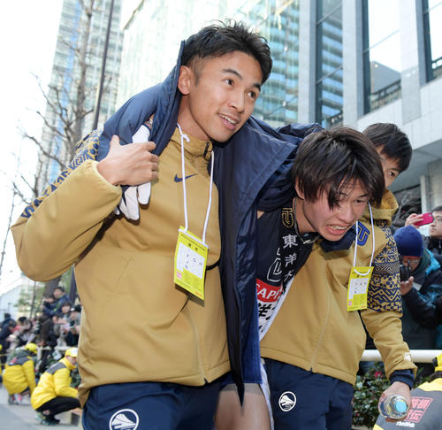 チームメートに支えられながら引き揚げる東洋大10区及川（中央）。左は相沢（撮影・横山健太）