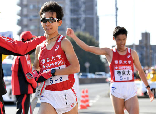 戸塚中継所でたすきリレーし走り出す帝京大9区小森（手前）。奥は8区鳥飼（撮影・滝沢徹郎）