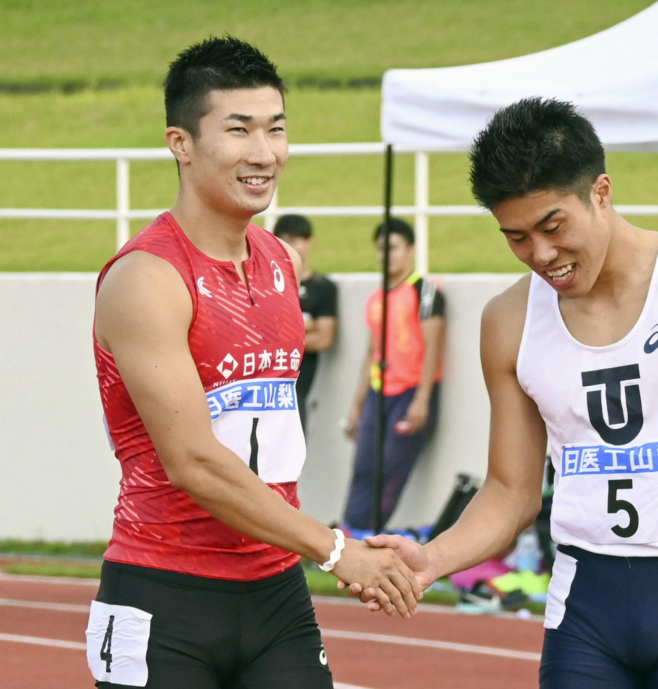 男子100メートル決勝で10秒04をマークして優勝し、笑顔を見せる桐生祥秀（左）（共同）