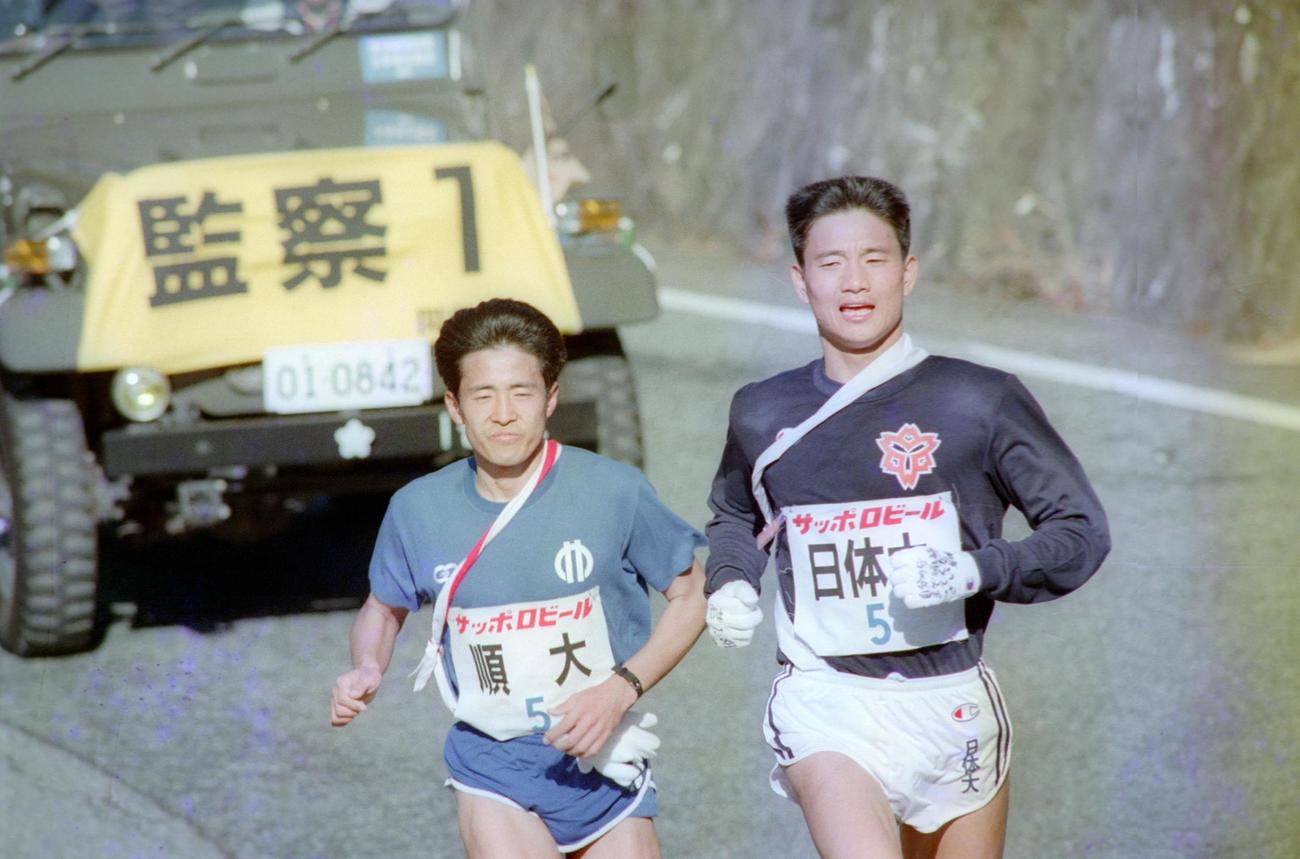 往路5区　日体大・島津秀一（右＝4年、区間1位）は、順天堂大・仲村明（左＝3年、区間2位）をとらえ、一時トップに出るも下りで再び順天堂大が抜き返す＝1989年1月2日