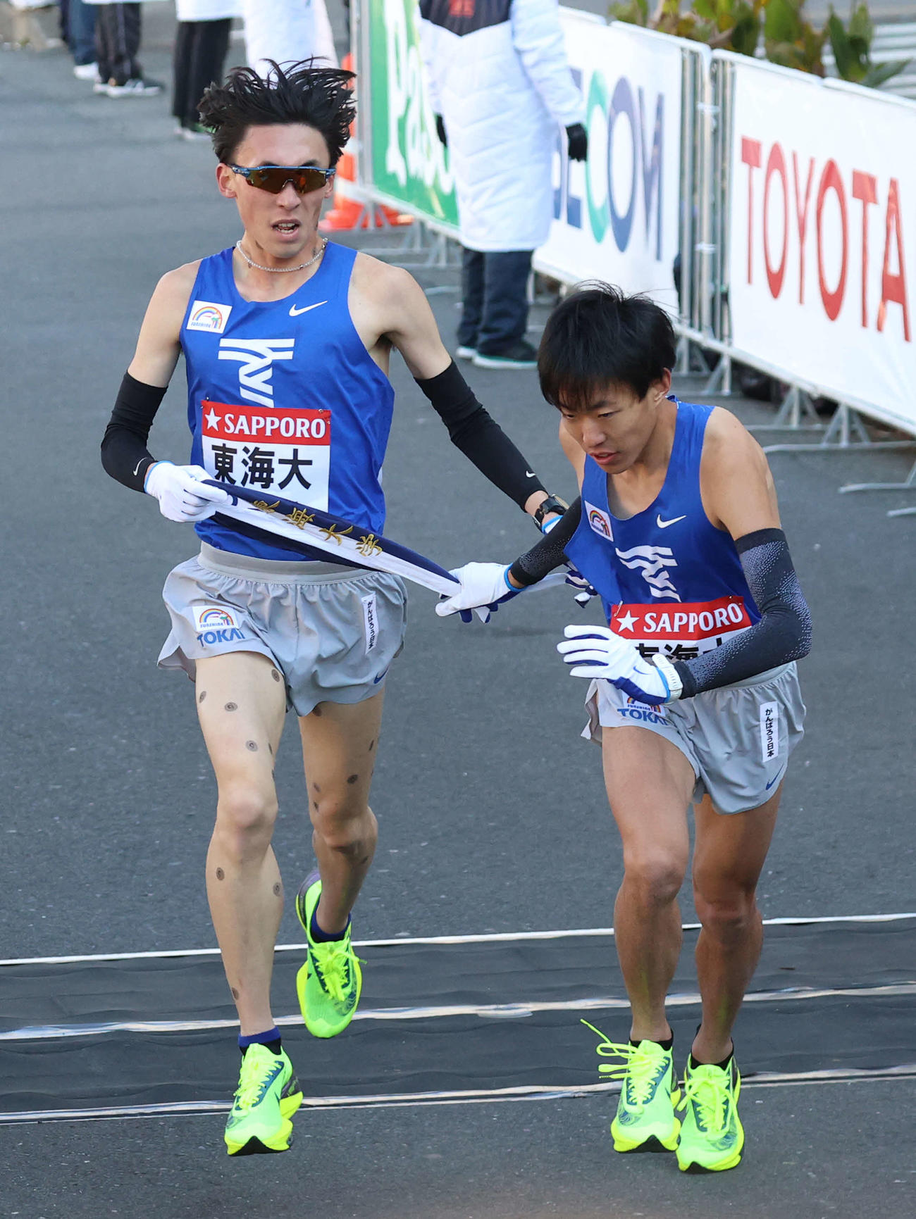 2位でタスキをつなぐ東海大1区塩沢（左）と2区名取（撮影・河野匠）