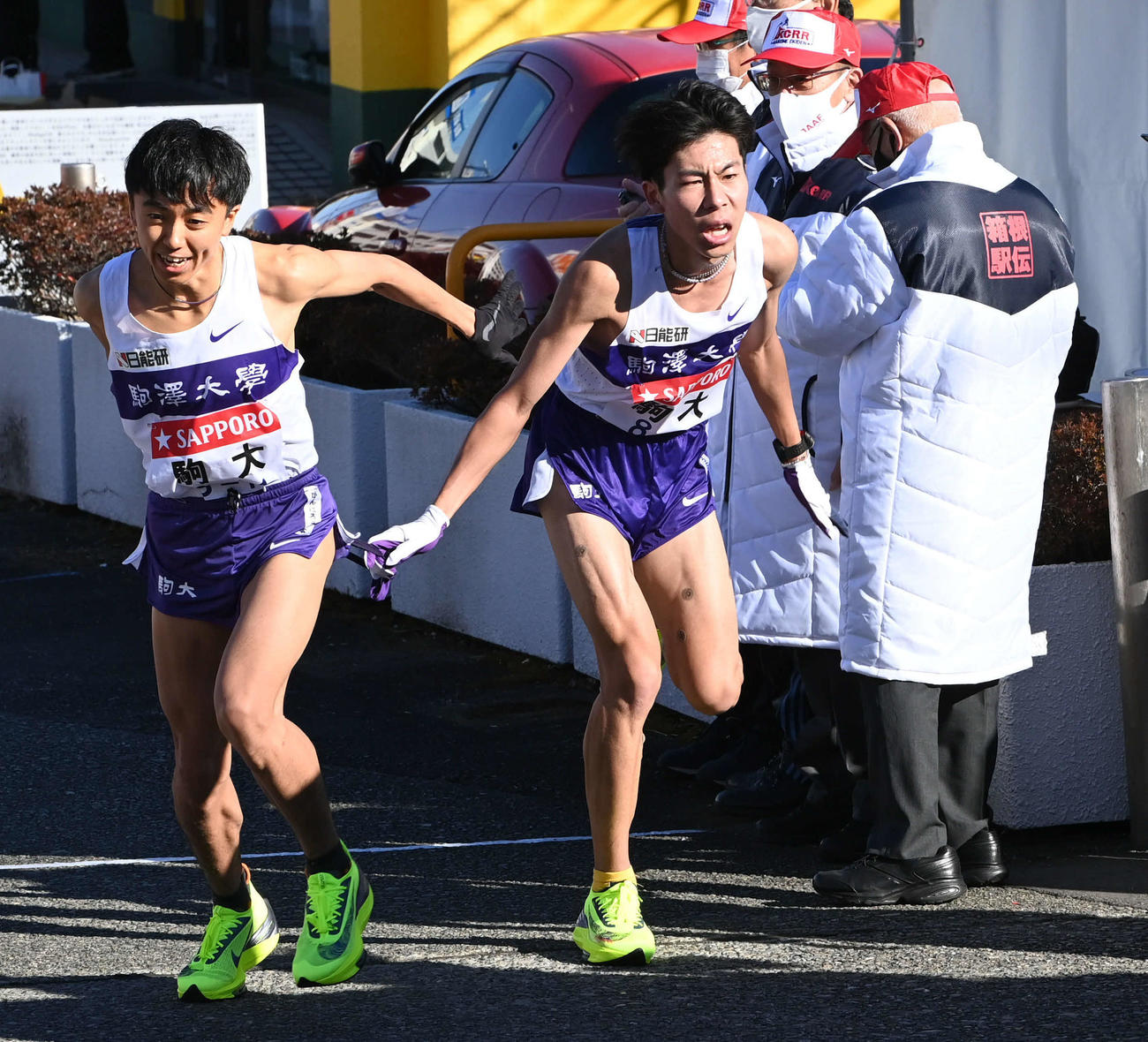 戸塚中継所で駒大2区田沢（右）は3区小林にたすきを渡す＝（撮影・山崎安昭）