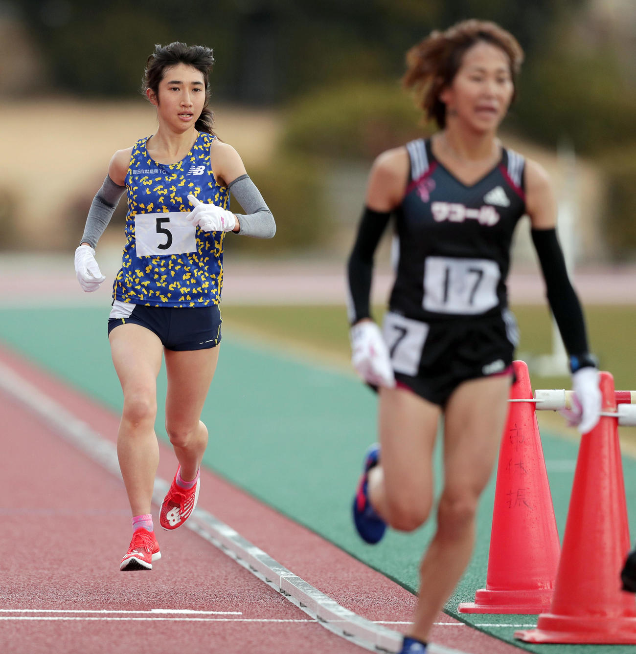 ラスト1周となり先頭を走る安藤（右）をとらえる田中（撮影・前田充）