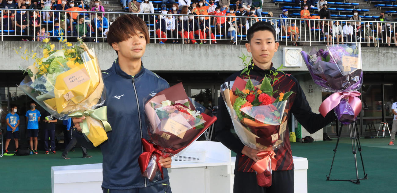 花束を受け取る男子110メートル障害の金井（左）と男子走り幅跳びの城山（撮影・保坂果那）