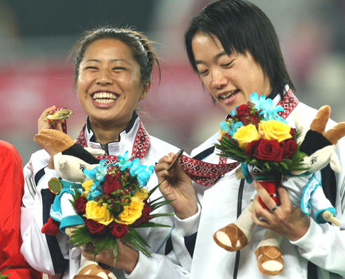 女子1万メートル決勝　ダントツ優勝の福士（左）は金メダルを手に満面の笑み