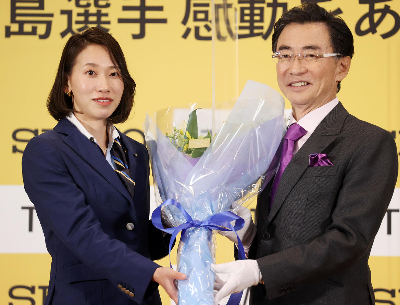 現役引退を発表した福島千里（左）はセイコーホールディングス服部真二代表取締役会長から花束を贈られ笑顔を見せる（撮影・浅見桂子）
