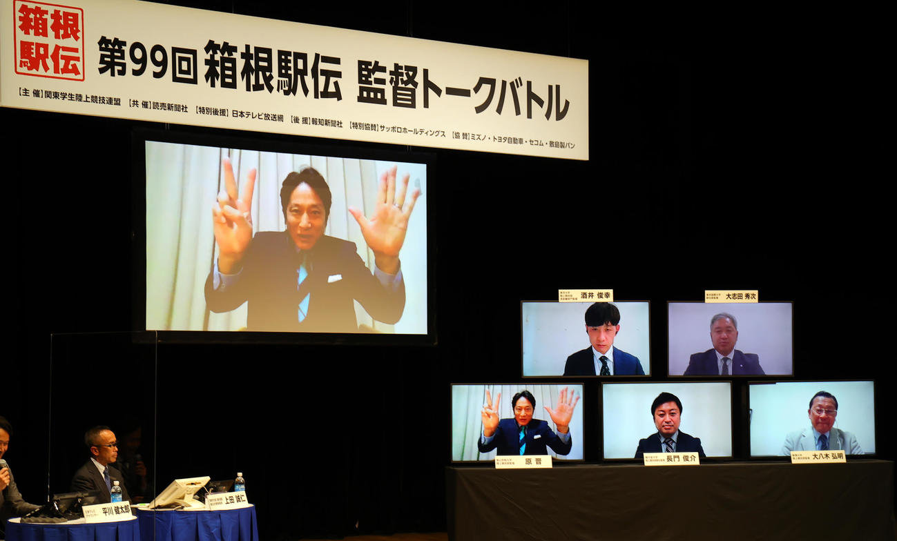 箱根駅伝監督トークバトルで、「ピース大作戦でゴール」と意気込む青学大・原監督（左大モニター）。右小モニター下段右から駒大・大八木監督、順大・長門監督、上段右から東京国際大・大志田監督、東洋大・酒井監督（撮影・野上伸悟）