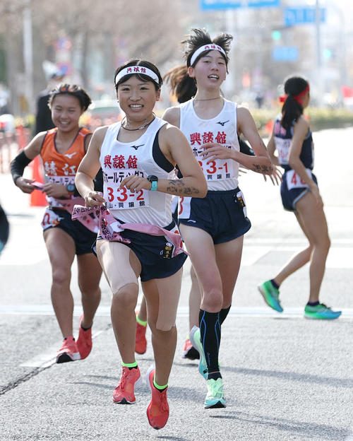 興譲館2区細見（手前）は1区奥本（右）からたすきを受け走り出す（撮影・上山淳一）