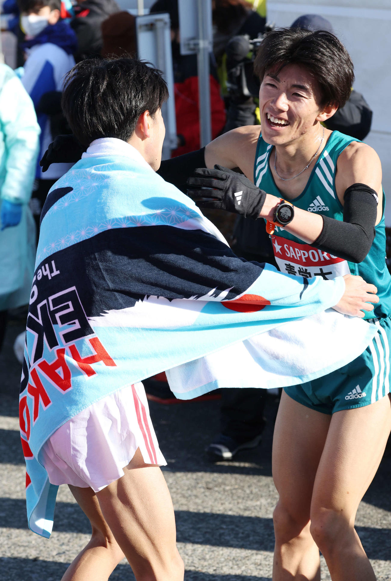 戸塚中継所で走り終え、中大2区吉居大（左）と抱擁を交わす青学大2区近藤（撮影・宮地輝）