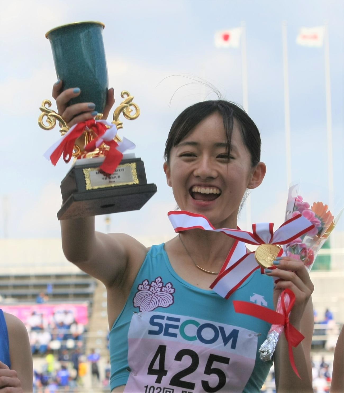 陸上関東インカレ女子1部1500メートル決勝　表彰式で優勝トロフィーとメダルを手にして笑顔を見せる筑波大・樫原（撮影・藤塚大輔）