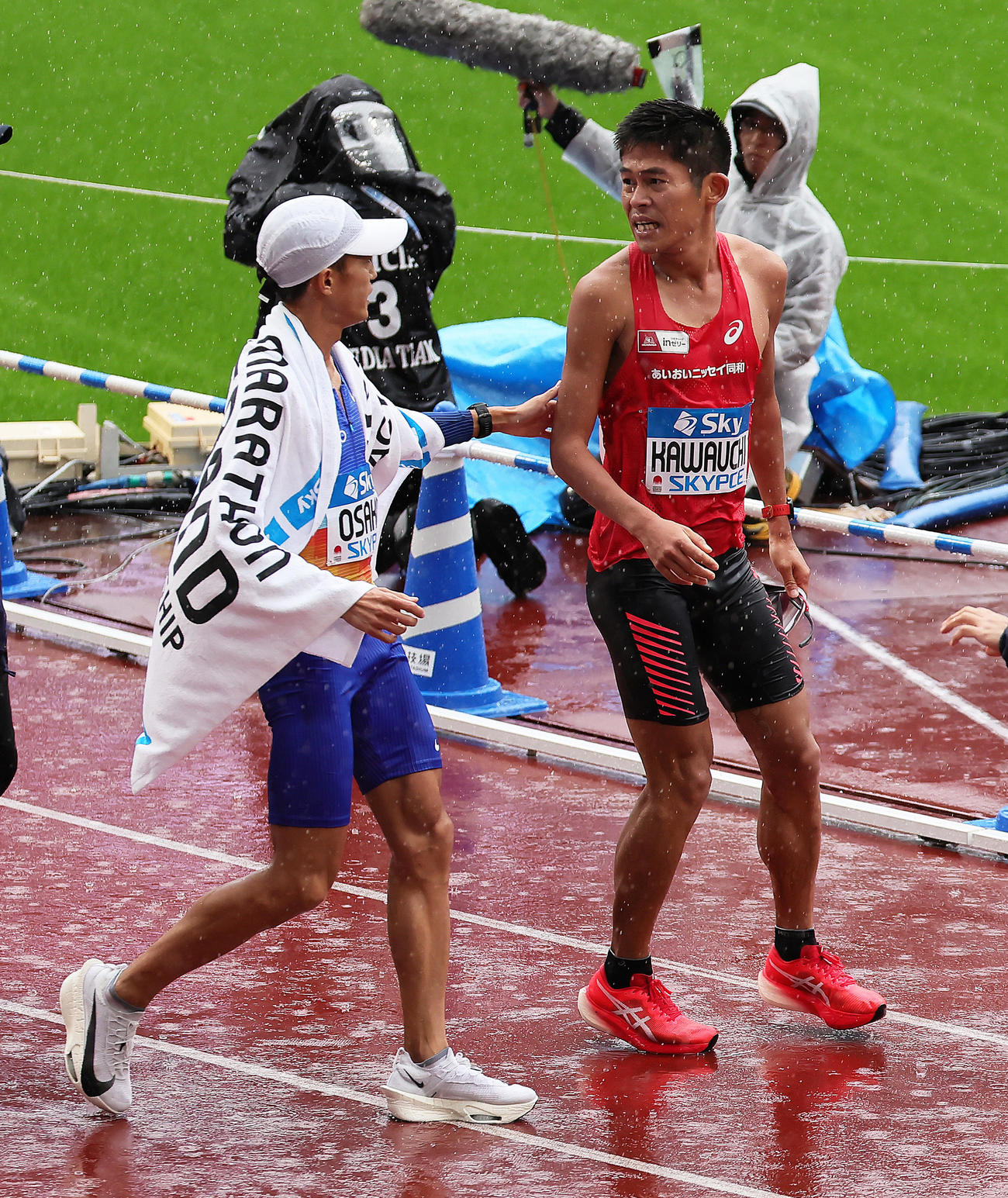 ゴールし健闘をたたえ合う3位大迫（左）と4位川内（撮影・足立雅史）