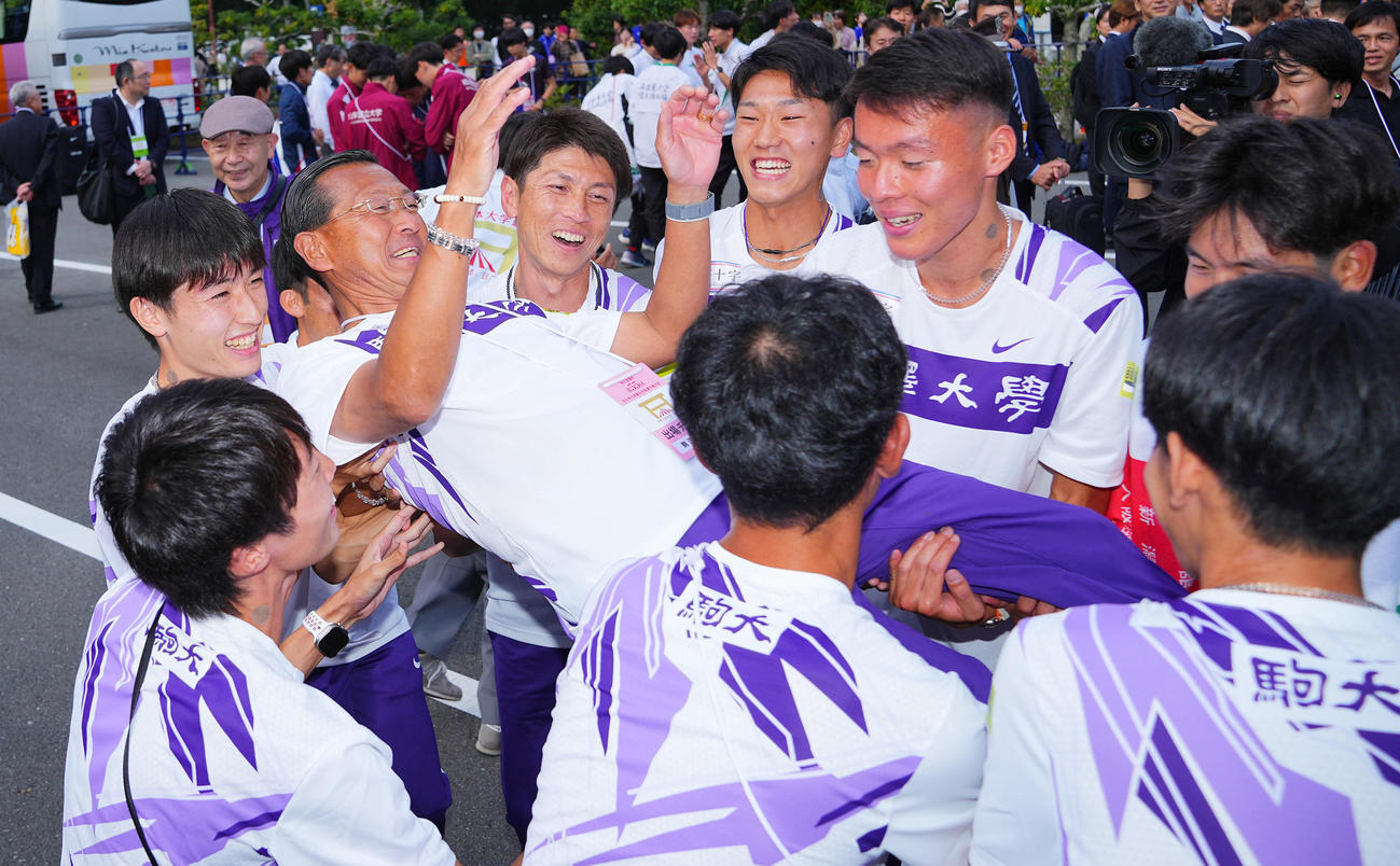 優勝を決め駒大・藤田監督（左から3人目）、2区を走った佐藤（同5人目）らから胴上げされる大八木総監督（中央）（撮影・垰建太）