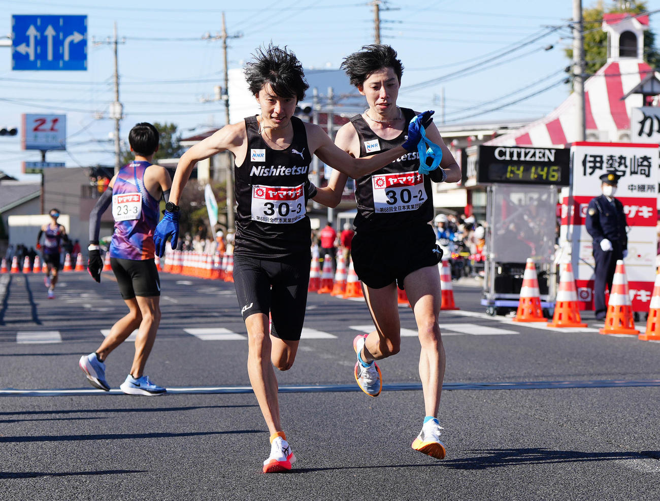 第2中継所でタスキリレーする西鉄・設楽兄弟。右は弟の2区悠太、左は3区の啓太（撮影・江口和貴）