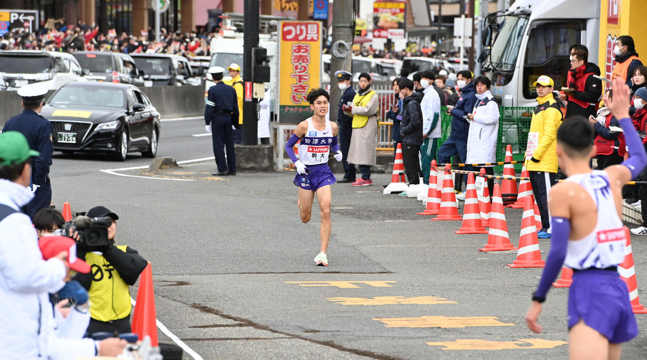 戸塚中継所にトップで駆け込む駒大2区鈴木（撮影・山崎安昭）