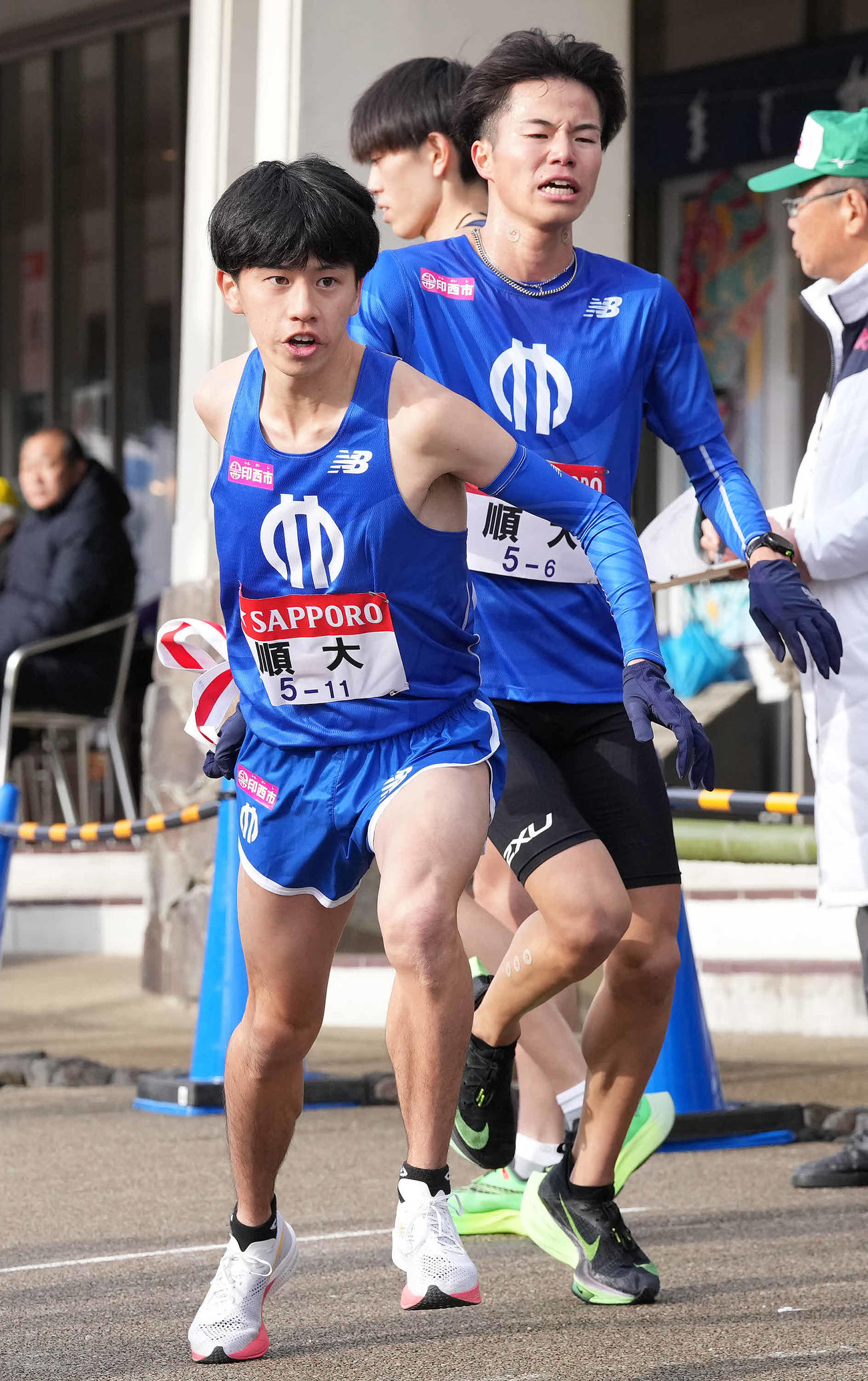 小田原中継所で7区内田（左）にたすきを渡す
順大6区氷見（撮影・鈴木みどり）