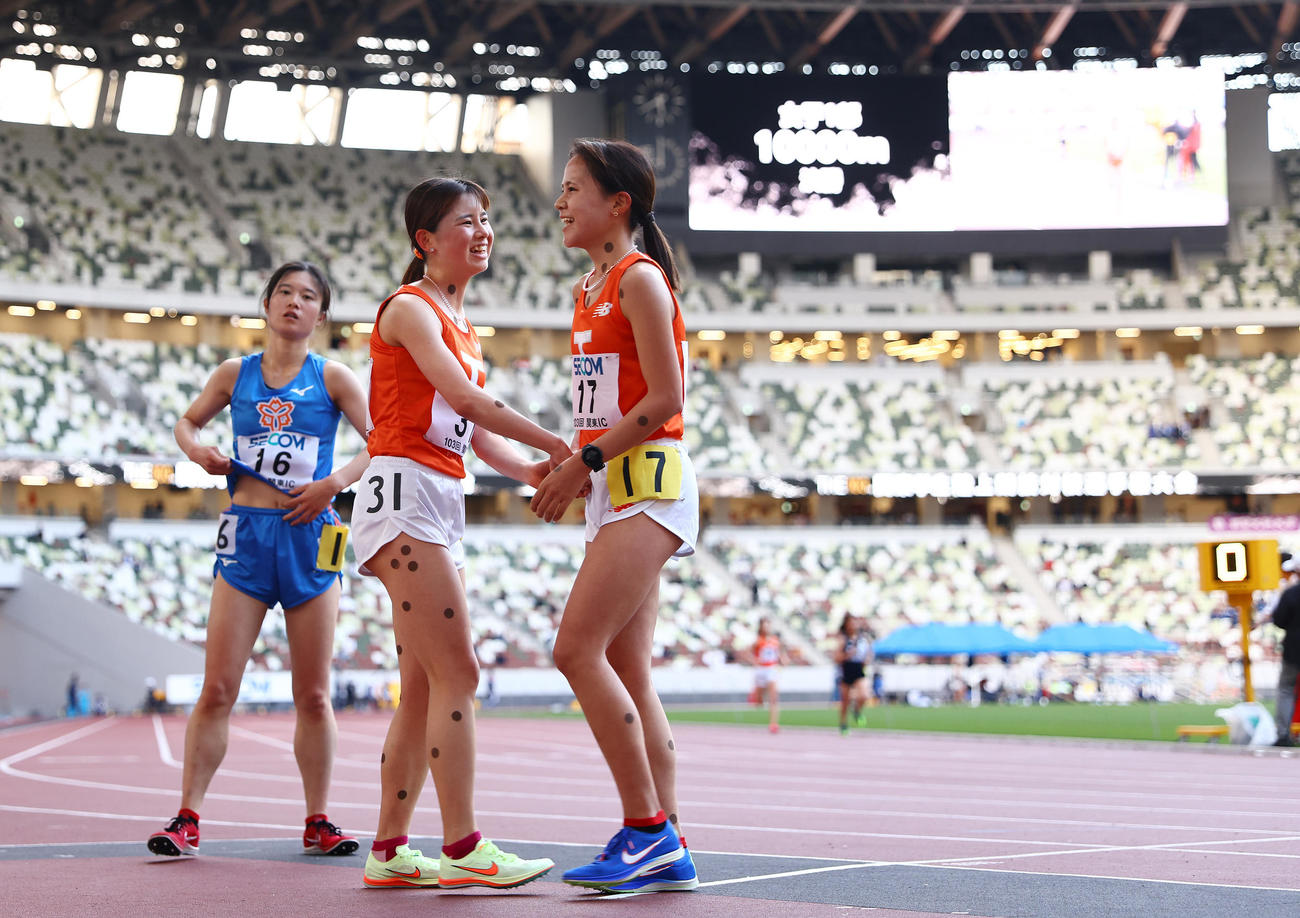 女子1万メートル決勝、レースを終えチームメートと笑顔で健闘をたたえ合う不破（中央）（撮影・垰建太）