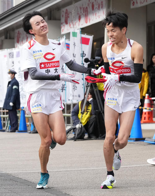 中大6区浦田（左）は7区岡田に小田原中継所でたすきを渡す（撮影・鈴木みどり）