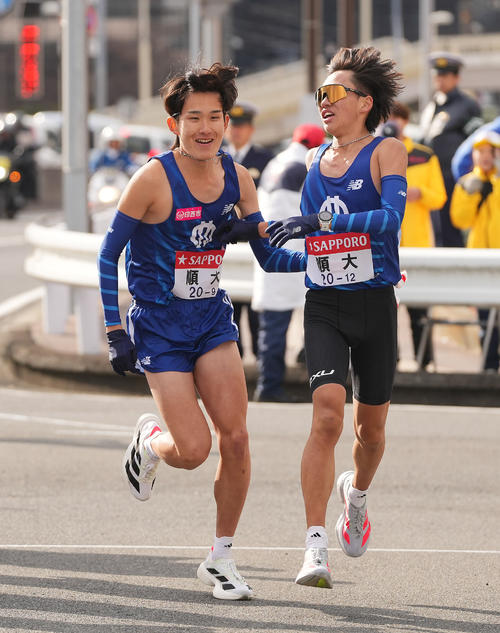 戸塚中継所でタスキリレーする順大8区荒牧（右）と9区石岡（撮影・垰建太）