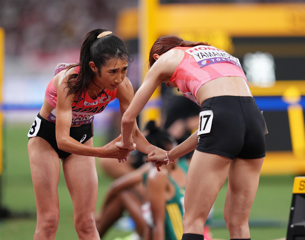 女子5000メートル予選　ゴールし手をつなぎ会話を交わす田中（左）と山本（撮影・足立雅史）
