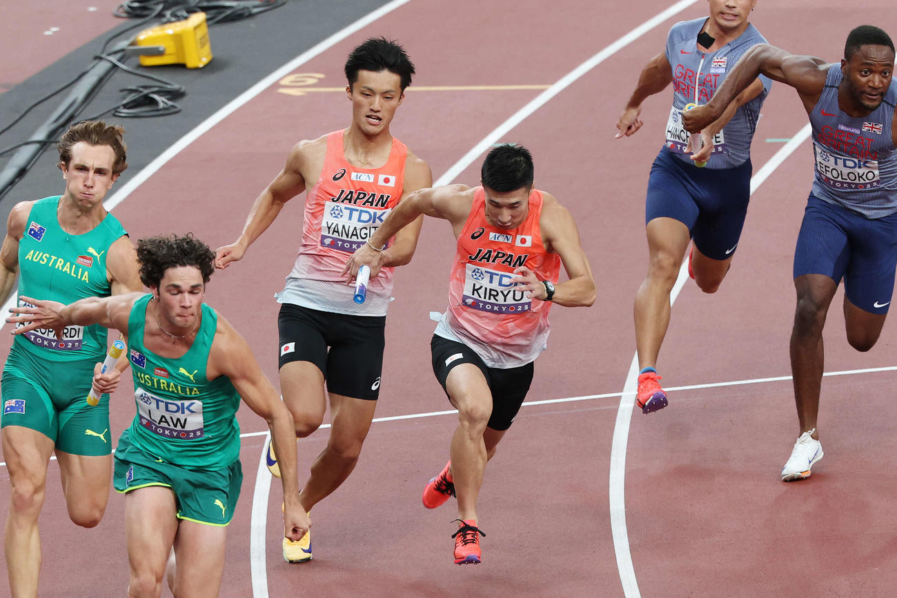 男子400メートルリレー予選　2走柳田（左）からバトンを受け取る3走桐生（撮影・宮地輝）
