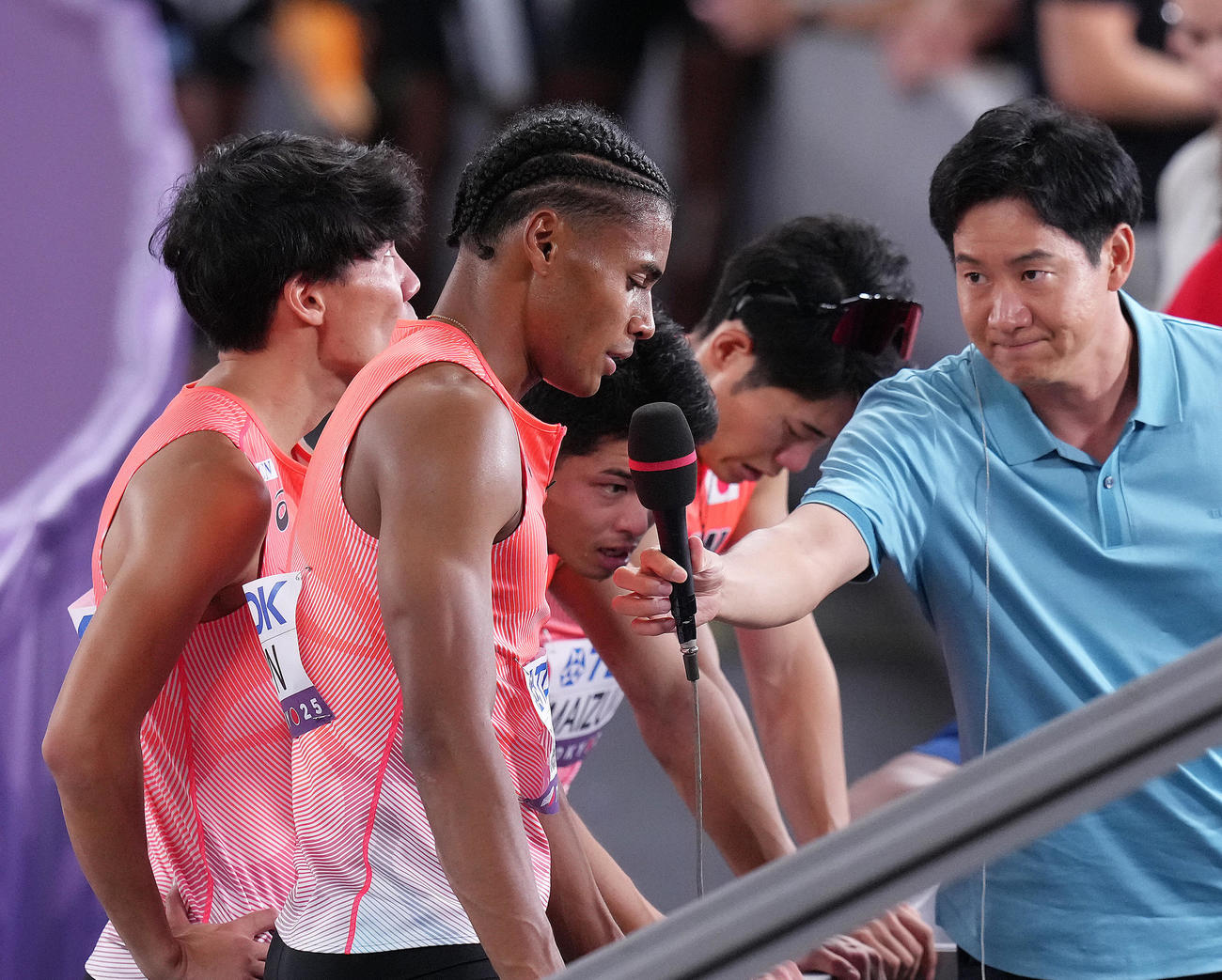 1600メートルリレー予選敗退となり厳しい表情でインタビューに答える中島（左から2人目）ら（撮影・足立雅史）