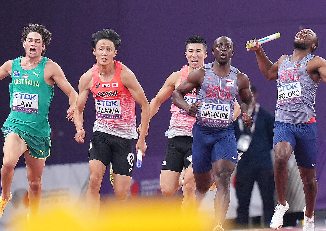 400メートルリレー予選　三走桐生（中央）からアンカー鵜沢（銅左）へバトンが渡る（撮影・足立雅史）